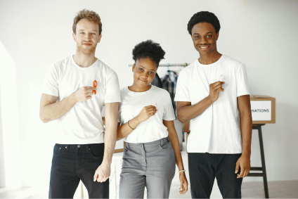 Recurring donors holding white and red ribbons